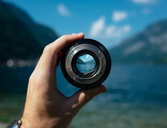 a hand holding a camera