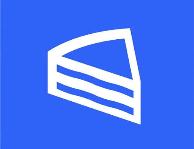 Simple white slice of cake icon on a solid blue background representing dessert or bakery.