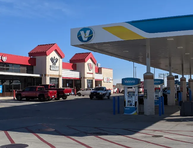 a gas station with cars parked