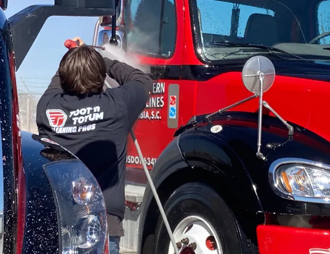 a man working on a red truck
