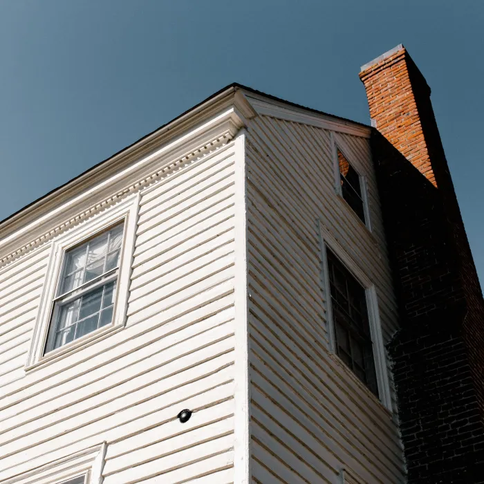 the side of a building with a tall chimney