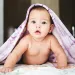 a baby lying on a blanket