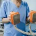 a doctor holding a device