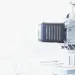 Close-up of industrial machinery with metallic components in a bright, white background environment