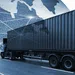 Large freight truck with container driving on road and global network connections overlay representing international shipping.