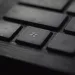 Close-up of a black computer keyboard with a focus on the Windows logo key and surrounding keys.