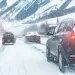 a group of cars on a snowy road