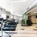 Modern gym interior featuring treadmills, ellipticals, and motivational signage.