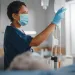 a nurse works in blue scrubs
