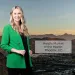Smiling woman in green blazer stands before Phoenix, AZ cityscape at sunset with market of the month text overlay.