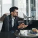 Two business professionals having a focused discussion over coffee in a modern office lounge area.