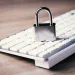 Silver padlock on a white computer keyboard symbolizing online cybersecurity and cyber security gaps