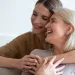 a woman kissing another woman's cheek
