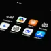 Close-up of smartphone screen showing AI app icons including ChatGPT vs Copilot.