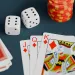 Poker cards with diamond face cards, dice, and colorful poker chips on a dark table background - casino cyber security