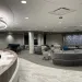 a room with a large round table and chairs