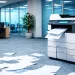 Office printer ejecting papers scattered on carpeted floor in a modern workspace with desks and chairs.