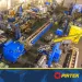 A large industrial workshop with blue machinery, yellow crane, and organized metalworking equipment.
