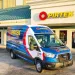 Blue and white PIRTEK service van parked outside a PIRTEK service and supply center building with company signage.