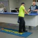 Customer and employee interacting at a service counter with Pirtek logo mat on the floor