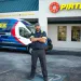 Technician standing confidently with arms crossed in front of a Pirtek service van and store entrance.