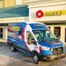 Pirtek service van parked outside a Pirtek hydraulic and industrial hose service center building.