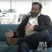 two men sitting on a couch