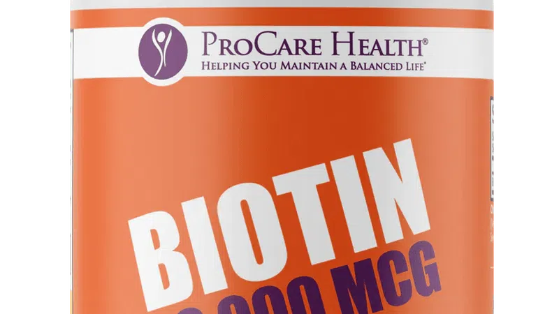 Bottle of ProCare Health Biotin 10,000 mcg dietary supplement with 120 capsules and mega dose label.