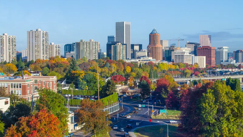 Portland city skyline with autumn foliage and busy roads under a clear blue sky in fall season.