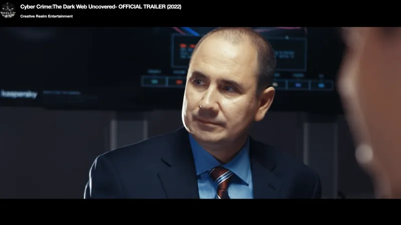 Man in suit and striped tie engaged in serious discussion with digital data screens in the background