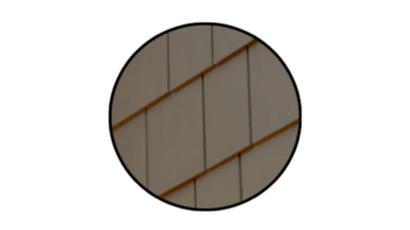 Close-up of beige wall tiles arranged in diagonal rows within a circular frame.