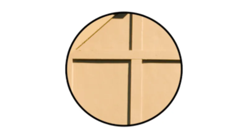 Close-up of beige paper with embossed cross-shaped lines inside a circular frame on white background.