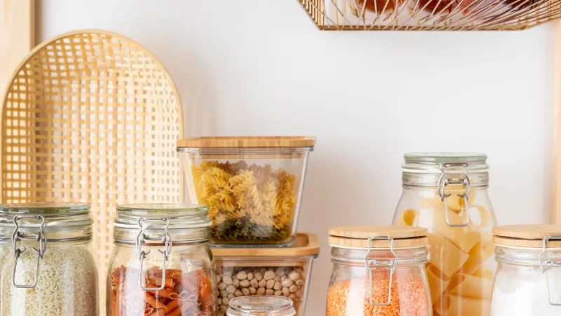 a group of glass jars with yellow liquid in them