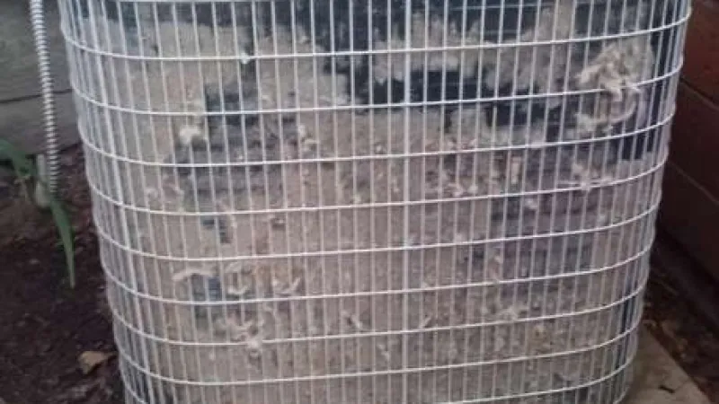 Outdoor air conditioning unit with a protective metal grill covered in accumulated pollen and debris in Marietta Ga