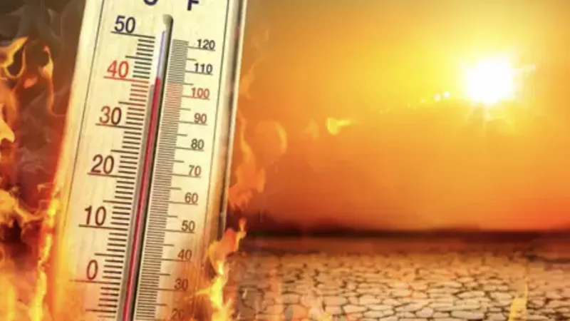 Thermometer showing high temperatures with flames and a cracked dry ground under a bright hot sun.