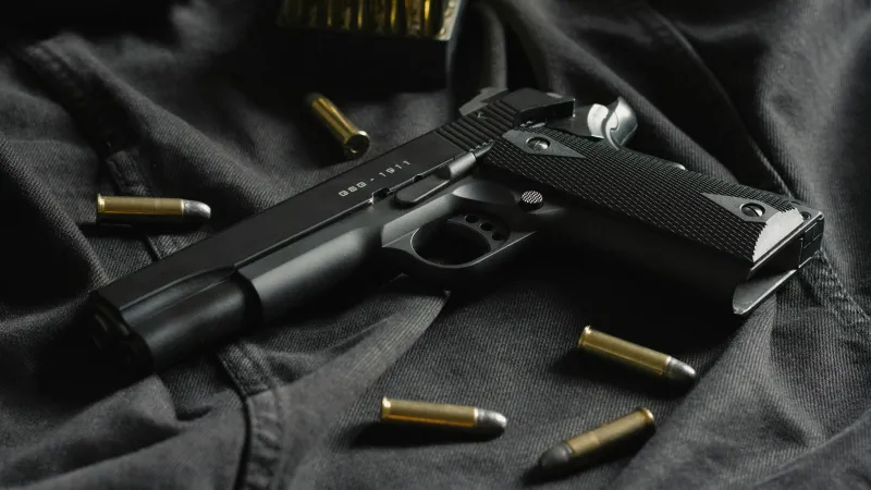 a gun on a person's lap