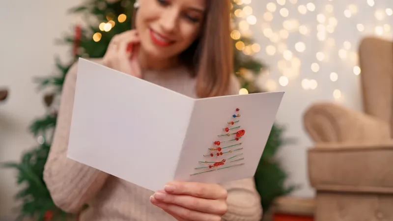 woman reading a holiday card
