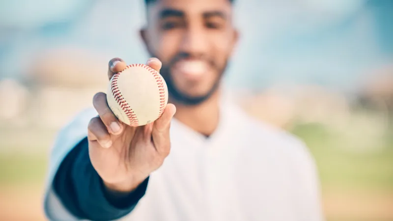 a person holding a baseball