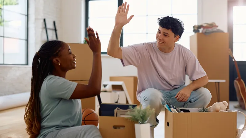 a man and a woman packing to move