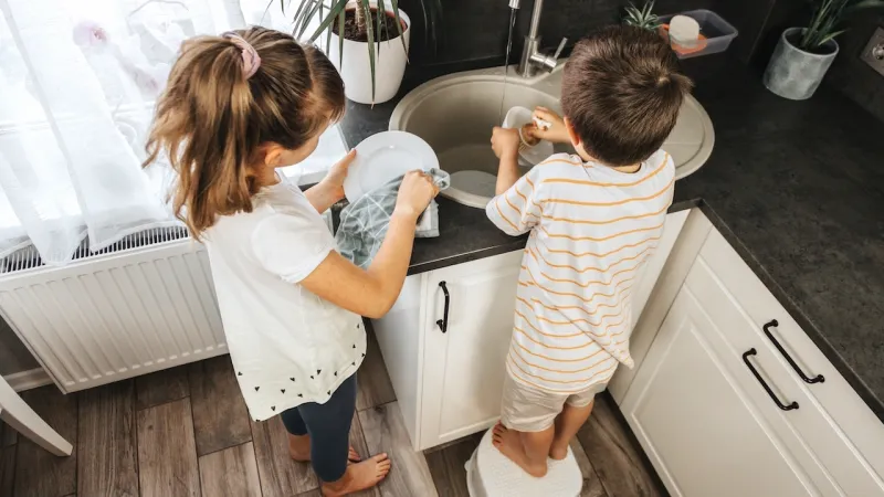 young boy and girl doing the dishes