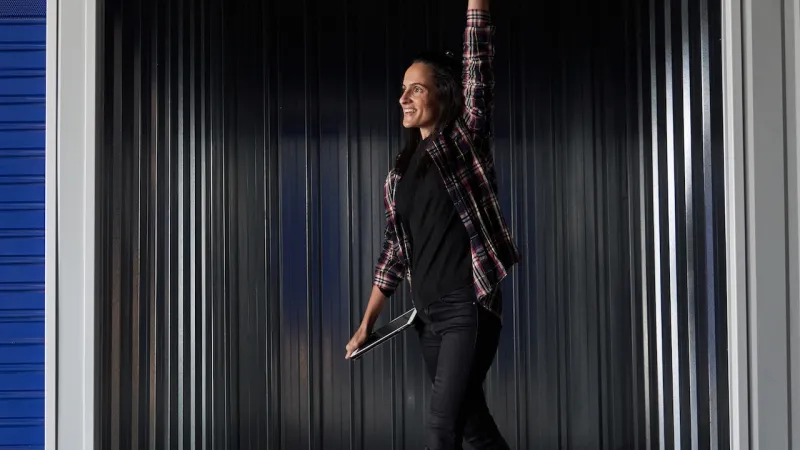 a person standing in front of climate-controlled storage unit