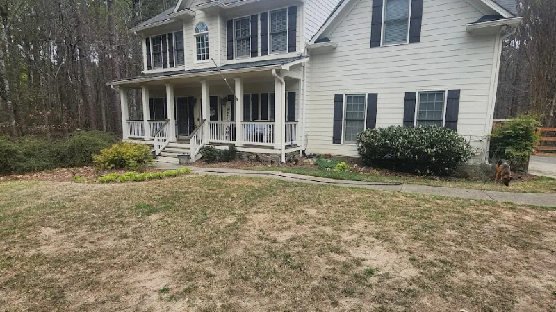 a house with a lawn and trees