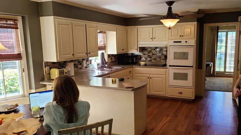 a kitchen with a soffit and old cabinets