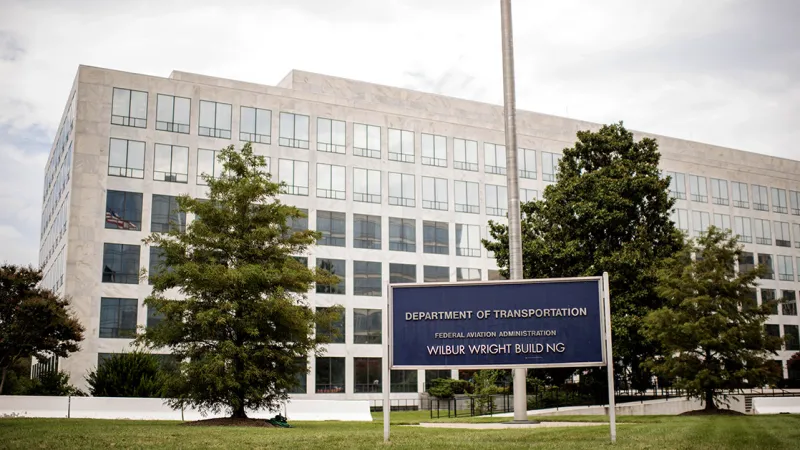 Department of Transportation Wilbur Wright Building with sign and surrounding trees under cloudy sky.