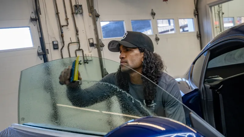 a person in a car with a fish in the mouth