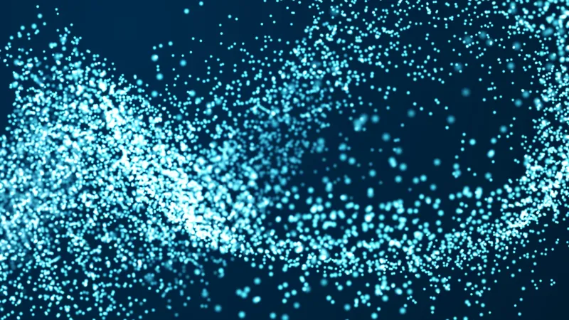 Abstract flow of bright blue particles forming wave-like patterns on a dark background.