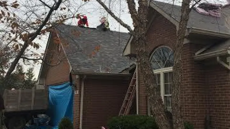 Here you see the garage door is protected from falling shingles. The shrubby areas have been cleaned, and the area has also been scoured by a magnet to pick up fallen nails. After installing the new roofing shingles, the magnet will be used again.