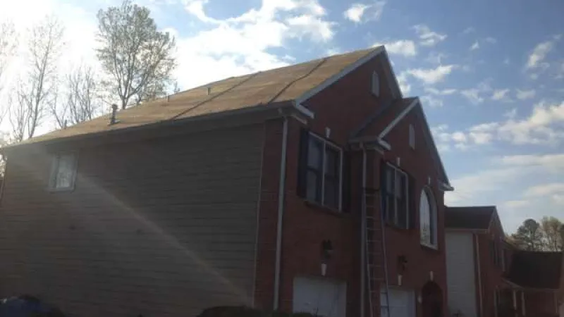 Shingles and felt removed down to the decking. All landscaping has been protected by tarps.