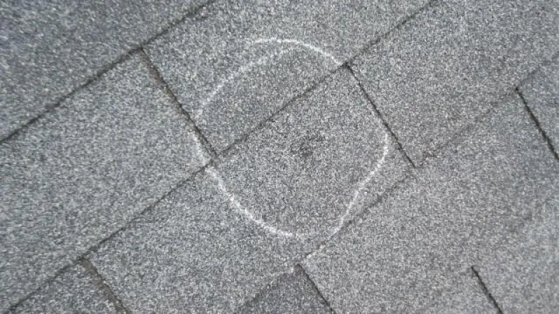 This roof in Marietta, GA really took a beating from the hail. Hailstones will crush the granules on the shingles down into the fiberglass and asphalt mat of the shingles, and they will knock other granules off of the impact area altogether. This compromises the water-shedding capability of the shingle and will become a leak point if not addressed!
