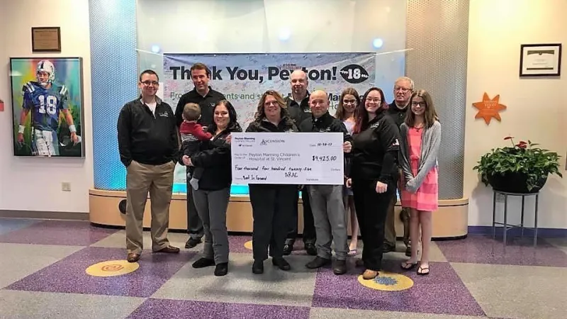 Roof It Forward presenting a check to the Peyton Manning Children's Hospital in 2017.